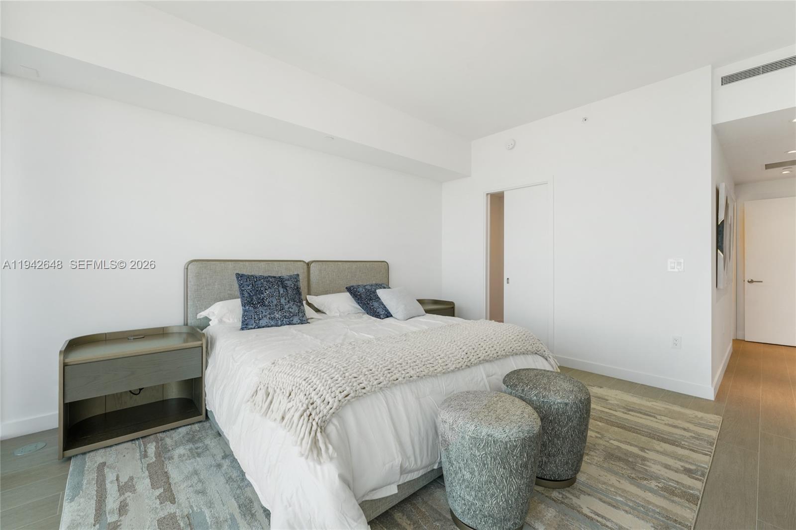 500 Alton Road, Unit 1506 Miami Beach, FL 33139 - Photo 11 of 21 a bedroom with a bed and wooden floor