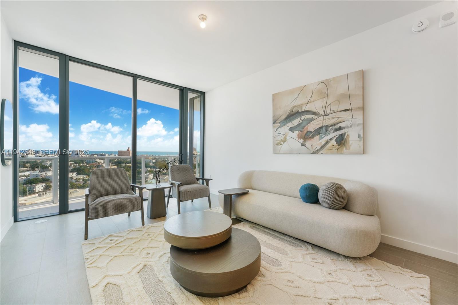 500 Alton Road, Unit 1506 Miami Beach, FL 33139 - Photo 2 of 21 a living room with furniture and a large window