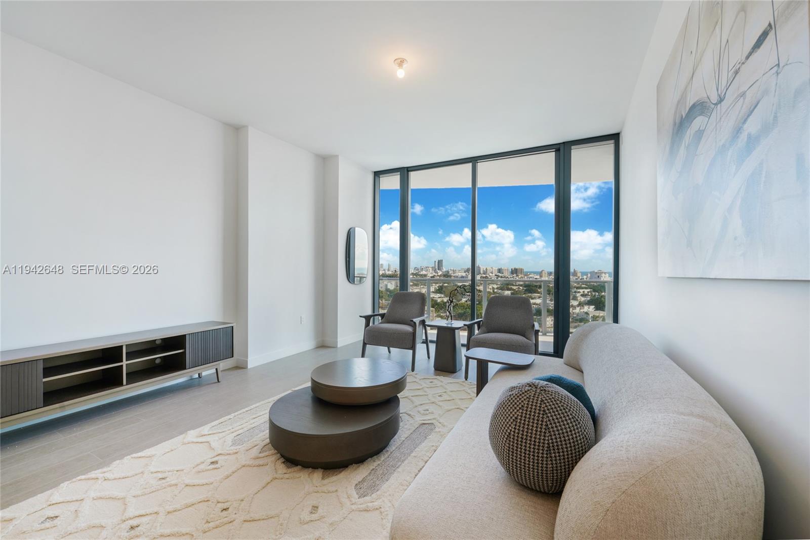 500 Alton Road, Unit 1506 Miami Beach, FL 33139 - Photo 3 of 21 a living room with furniture and a floor to ceiling window