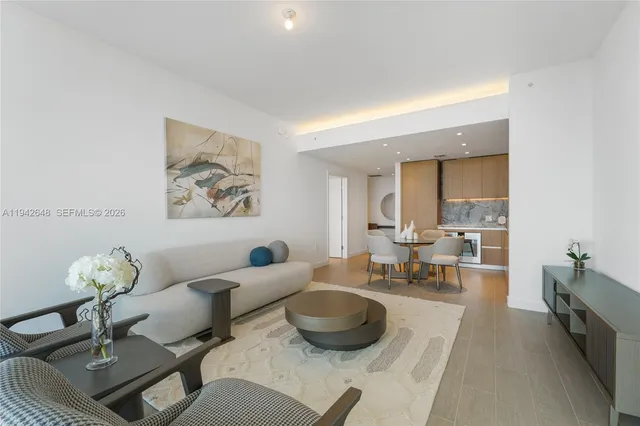 a living room with furniture and a potted plant