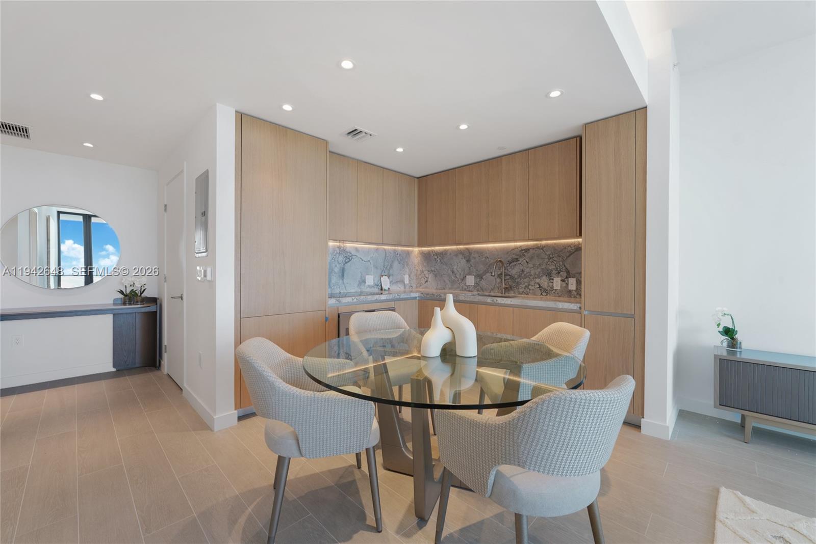 500 Alton Road, Unit 1506 Miami Beach, FL 33139 - Photo 6 of 21 a view of a dining room with furniture and wooden floor