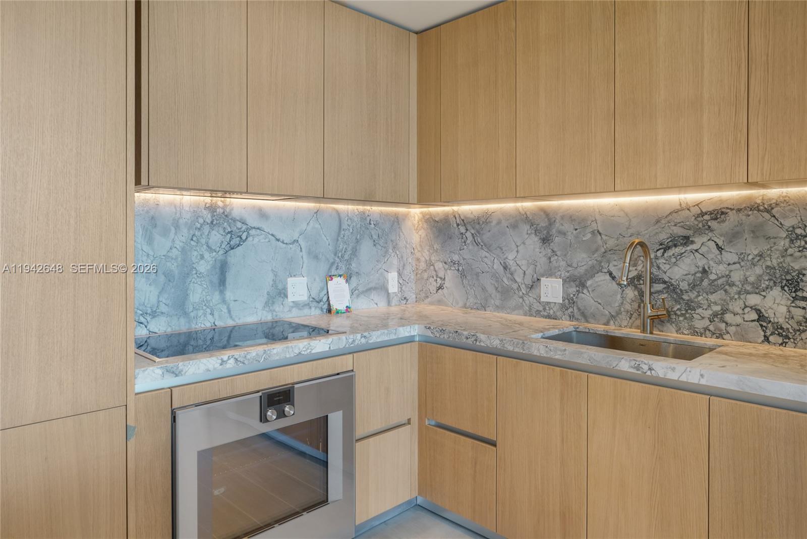 500 Alton Road, Unit 1506 Miami Beach, FL 33139 - Photo 7 of 21 a kitchen with a sink and cabinets