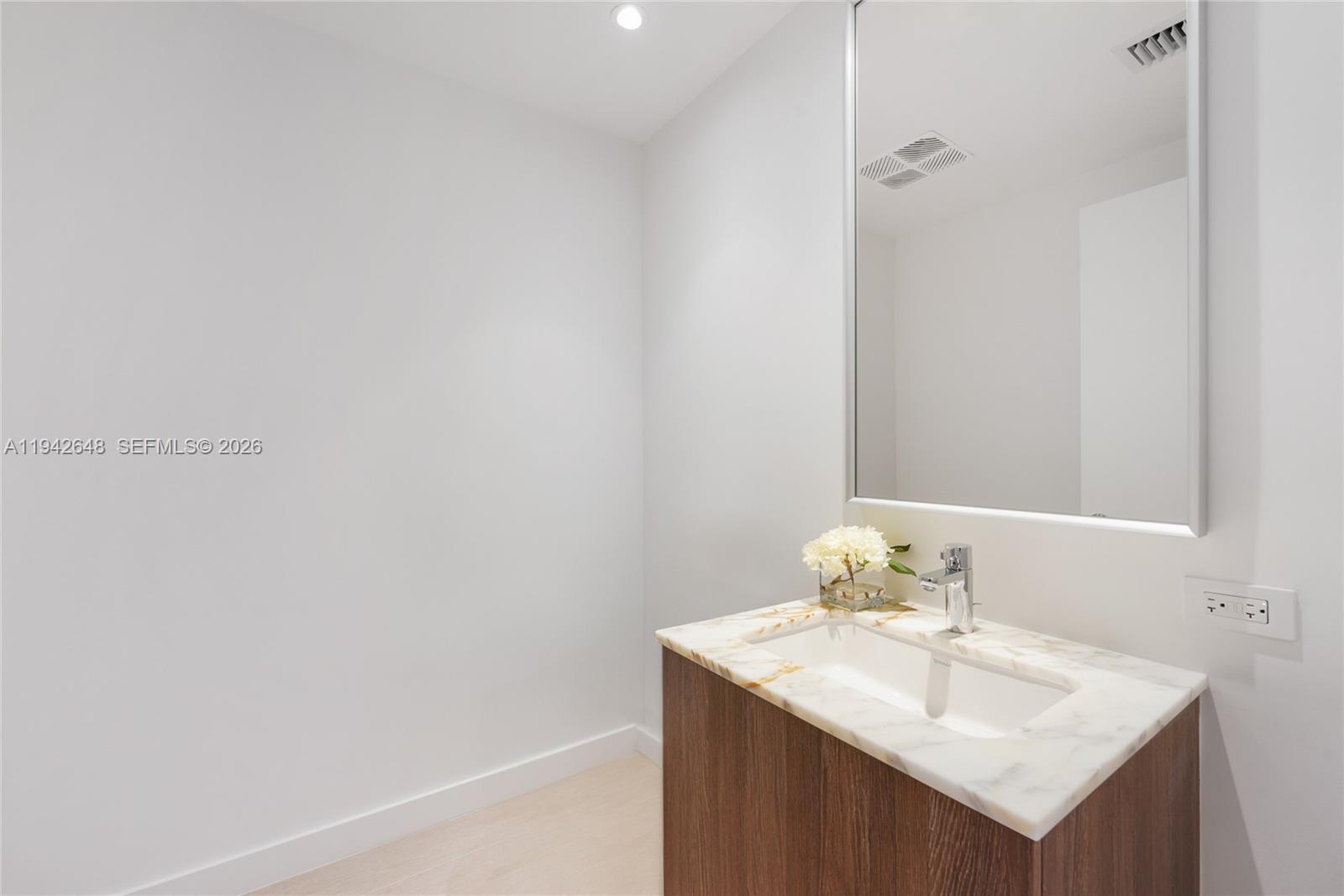 500 Alton Road, Unit 1506 Miami Beach, FL 33139 - Photo 8 of 21 a bathroom with a sink and a mirror