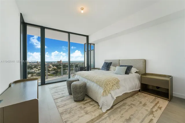 a spacious bedroom with a bed and a large window