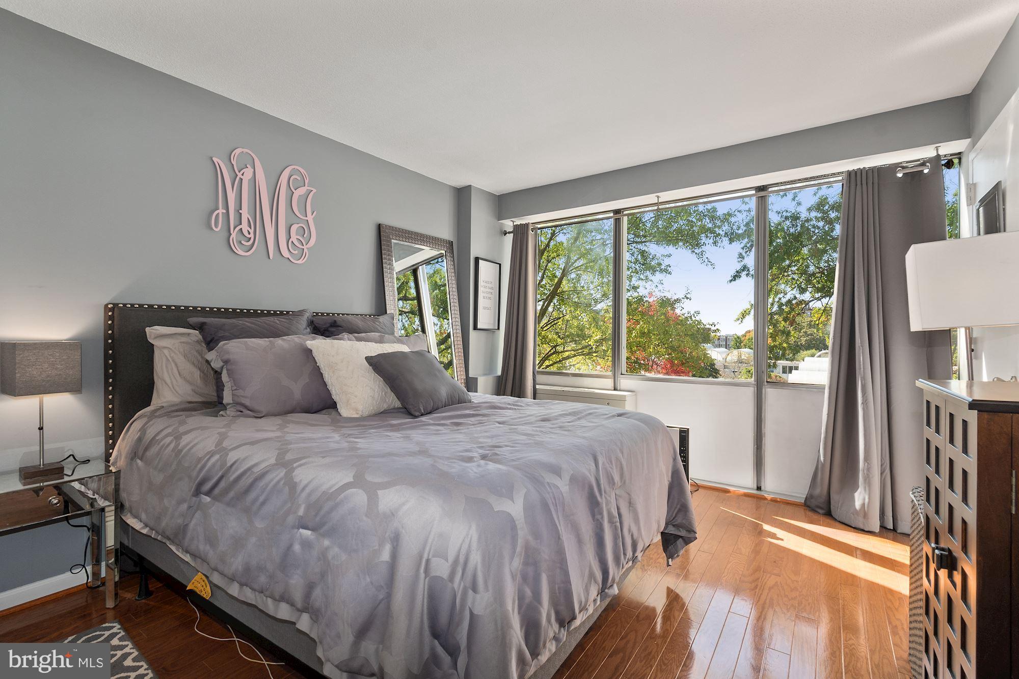 1311 Delaware Avenue Southwest, Unit S346 Washington, DC 20024 - Photo 11 of 27 a bedroom with a large bed and a large window with outer view