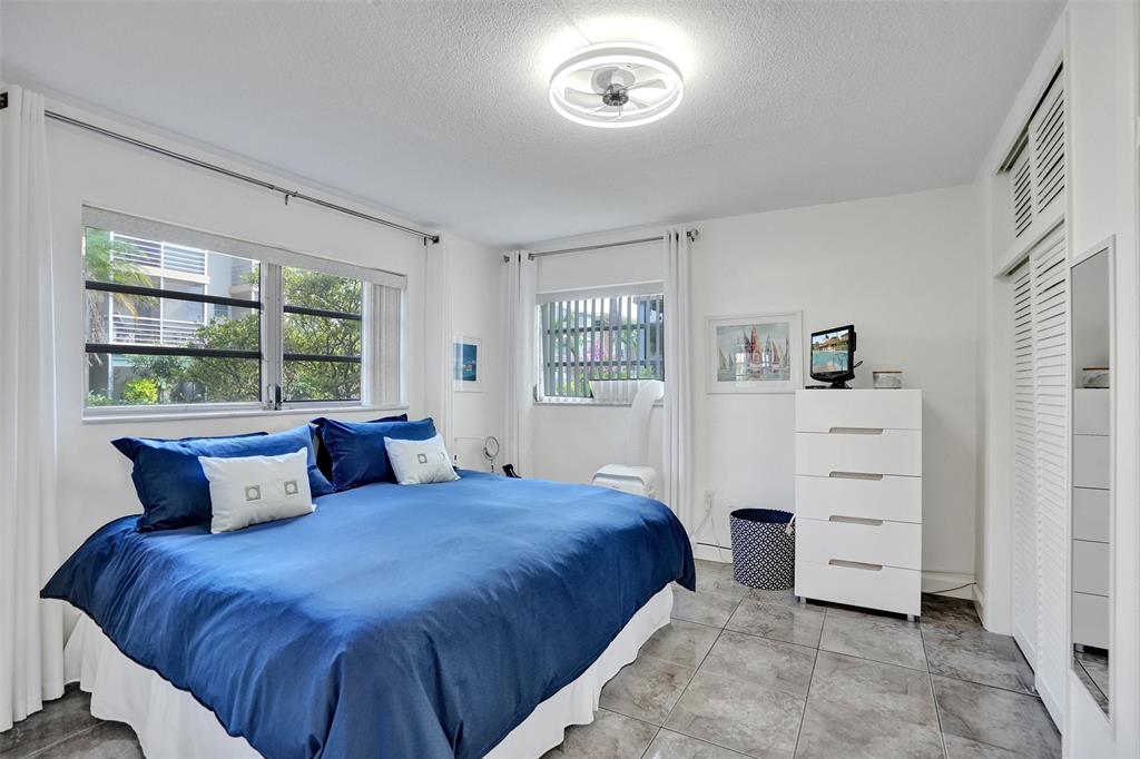 17001 Northeast 13th Avenue, Unit 104 Miami, FL 33162 - Photo 16 of 41 a bedroom with a bed and a window