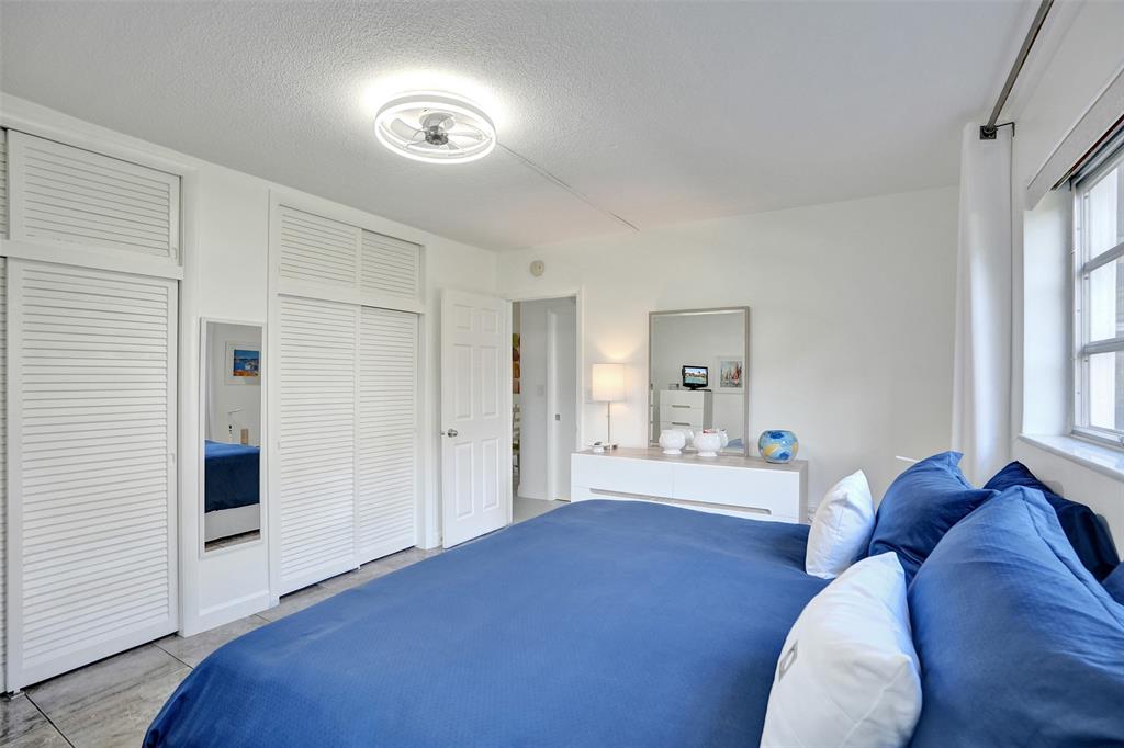 17001 Northeast 13th Avenue, Unit 104 Miami, FL 33162 - Photo 18 of 41 a living room with a bed furniture and next to a window