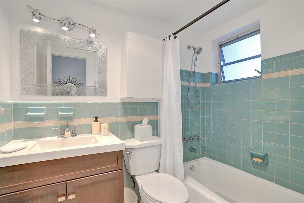 17001 Northeast 13th Avenue, Unit 104 Miami, FL 33162 - Photo 20 of 41 a bathroom with a sink a toilet and shower