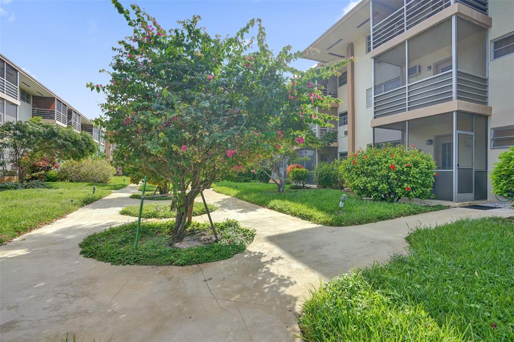 17001 Northeast 13th Avenue, Unit 104 Miami, FL 33162 - Photo 28 of 41 a front view of a house with a yard
