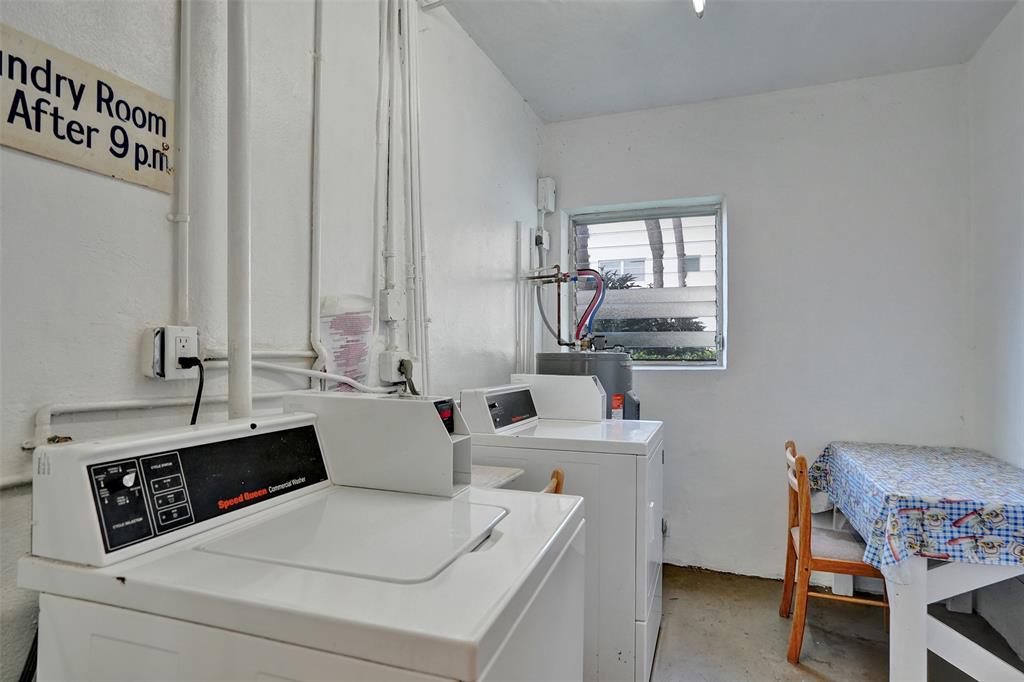 17001 Northeast 13th Avenue, Unit 104 Miami, FL 33162 - Photo 37 of 41 a room with a table chairs and two windows