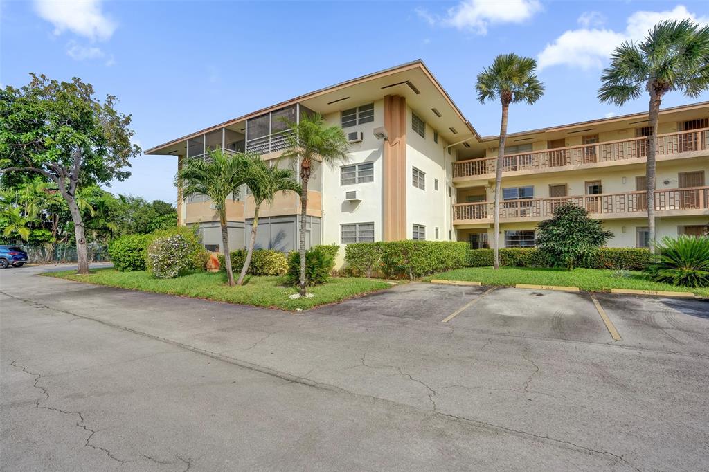 17001 Northeast 13th Avenue, Unit 104 Miami, FL 33162 - Photo 39 of 41 front view of a building with a yard