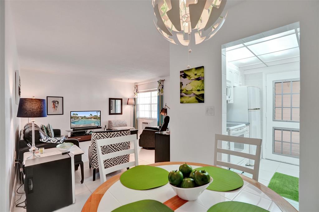 17001 Northeast 13th Avenue, Unit 104 Miami, FL 33162 - Photo 9 of 41 a living room with furniture and a wooden floor