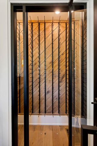 a spacious bathroom with a double vanity sink a large mirror and shower