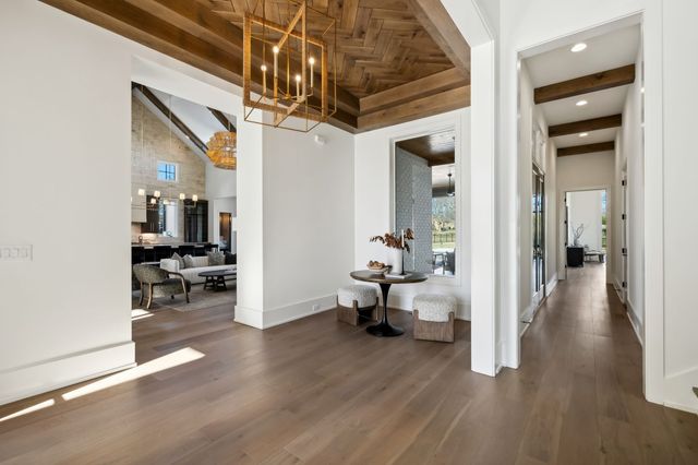 a spacious bathroom with a tub a double vanity sink and a large mirror
