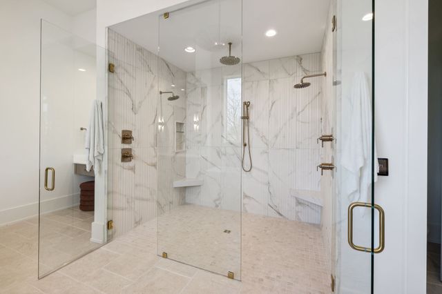 a front view of a house with yard and green space