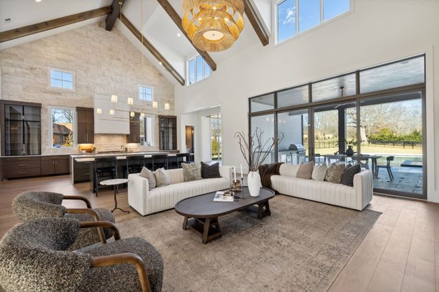 a large kitchen with a table and chairs in it