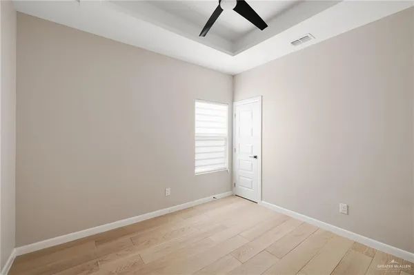 an empty room with windows and closet
