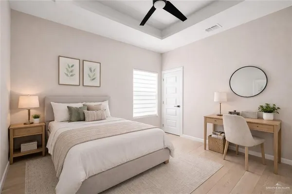 a bedroom with a bed a table and chair
