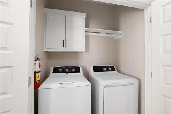 a view of storage and utility room with washer and dryer