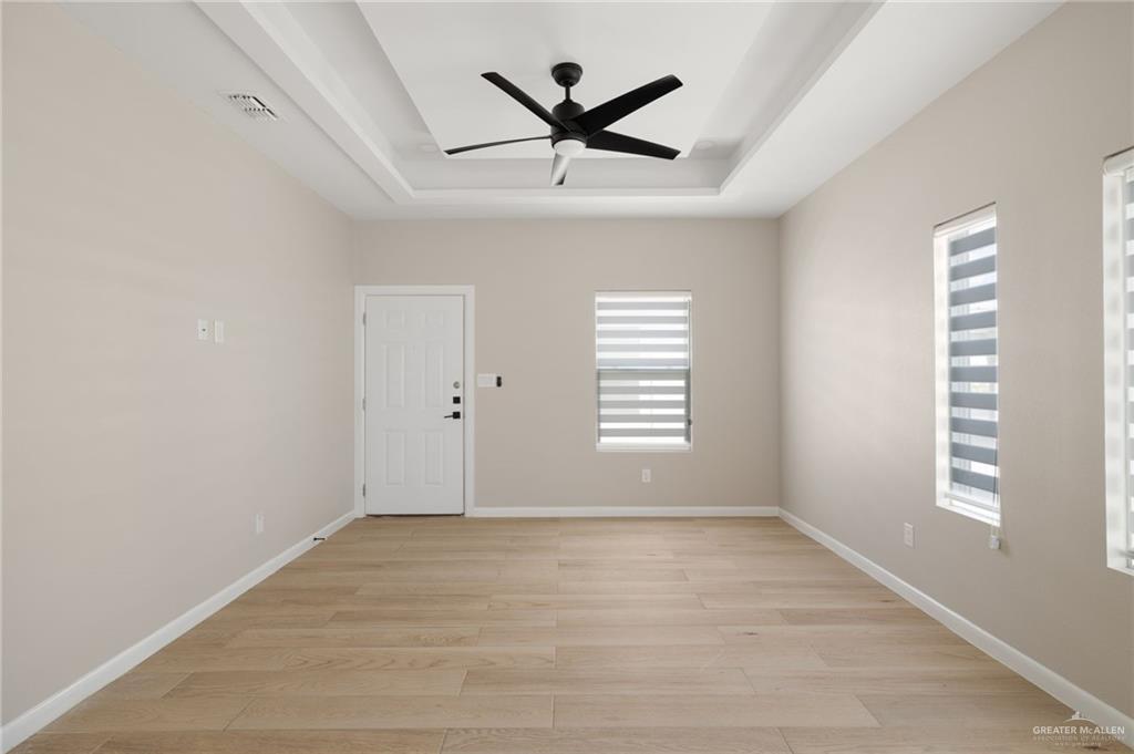 5812 Northwestern Avenue, Unit 3 Mission, TX 78573 - Photo 2 of 10 an empty room with window and ceiling fan