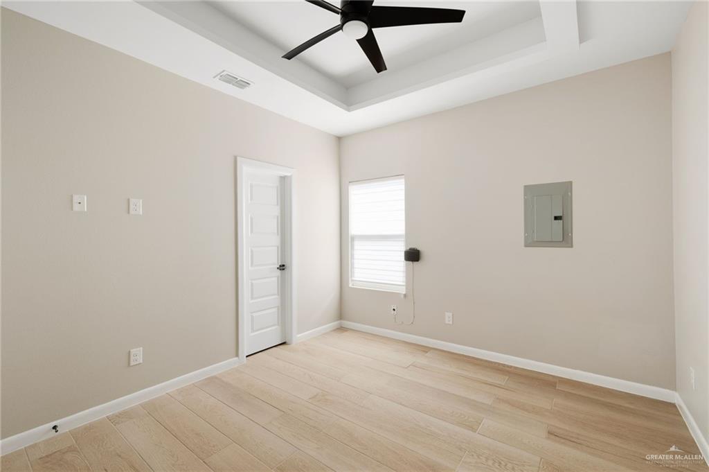 5812 Northwestern Avenue, Unit 3 Mission, TX 78573 - Photo 6 of 10 an empty room with a ceiling fan and carpet