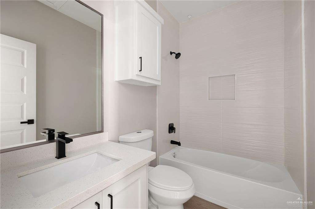 5812 Northwestern Avenue, Unit 3 Mission, TX 78573 - Photo 9 of 10 a bathroom with a sink a toilet and shower