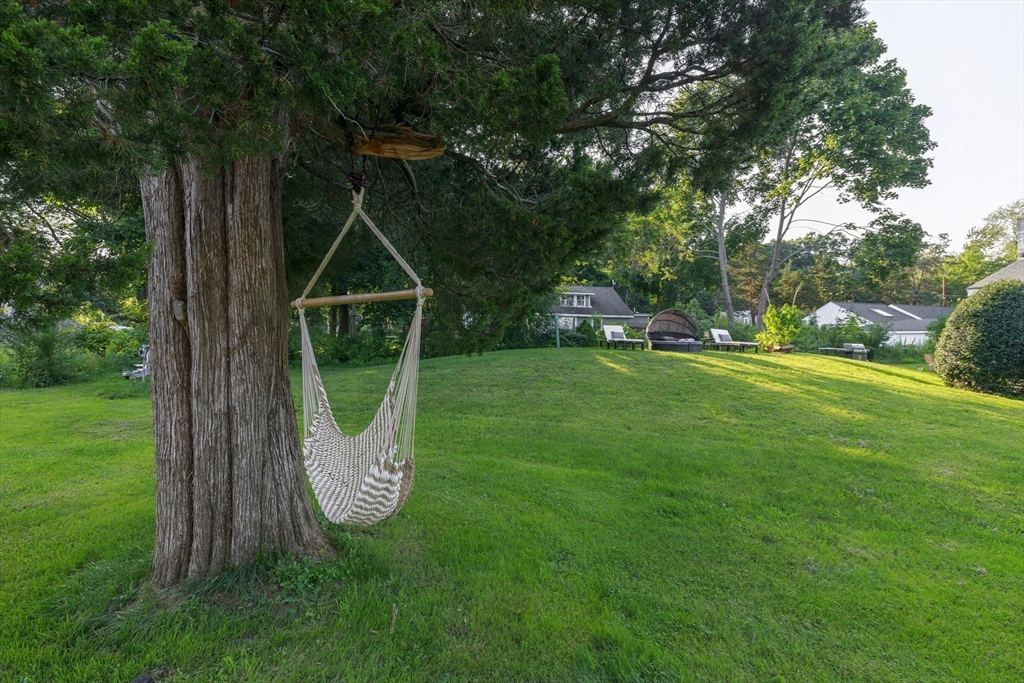 70 Cottage Road Newbury, MA 01951 - Photo 19 of 25 a view of a park with a slide trees and wooden fence