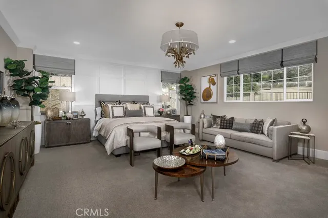 a bedroom with furniture and a large window