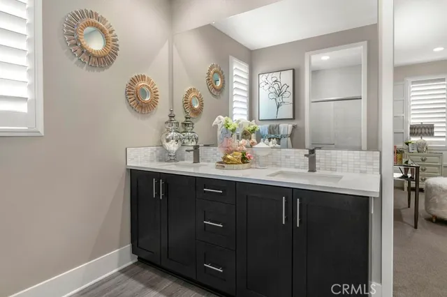 a bathroom with a double vanity sink and a mirror