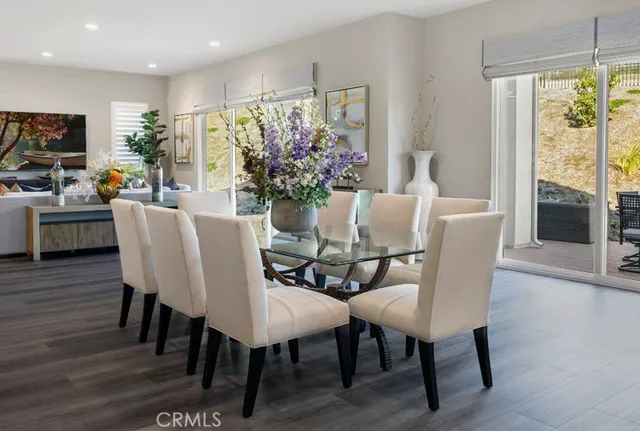 a view of a dining room with furniture window and wooden floor