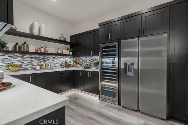 a kitchen with stainless steel appliances a refrigerator and a sink