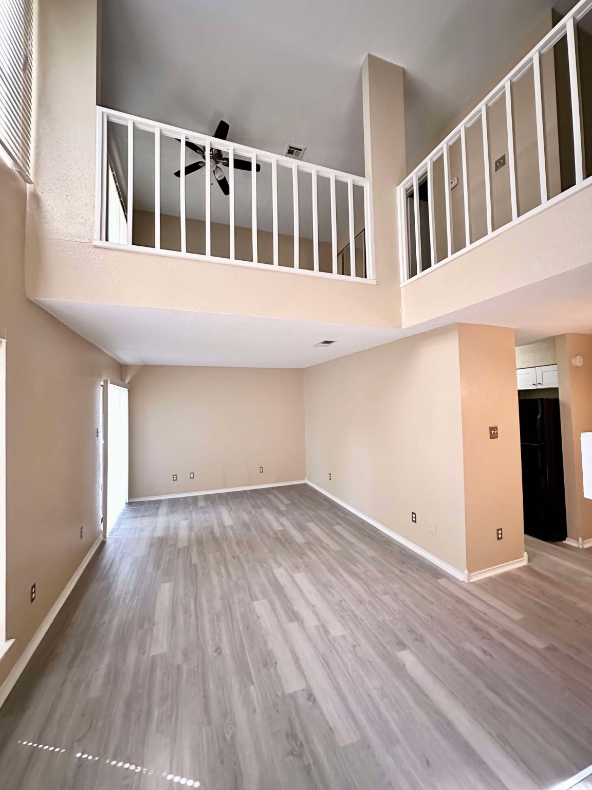 3630 Ocee Street Houston, TX 77063 - Photo 4 of 21 a view of an empty room with wooden floor and windows