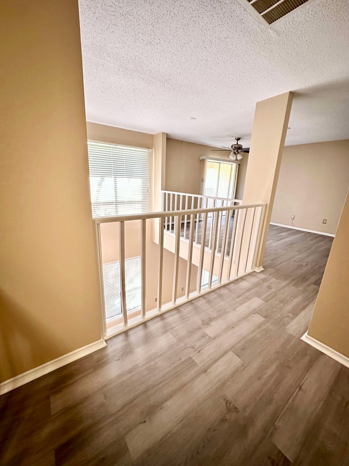 3630 Ocee Street Houston, TX 77063 - Photo 9 of 21 a view of an empty room with wooden floor and a window
