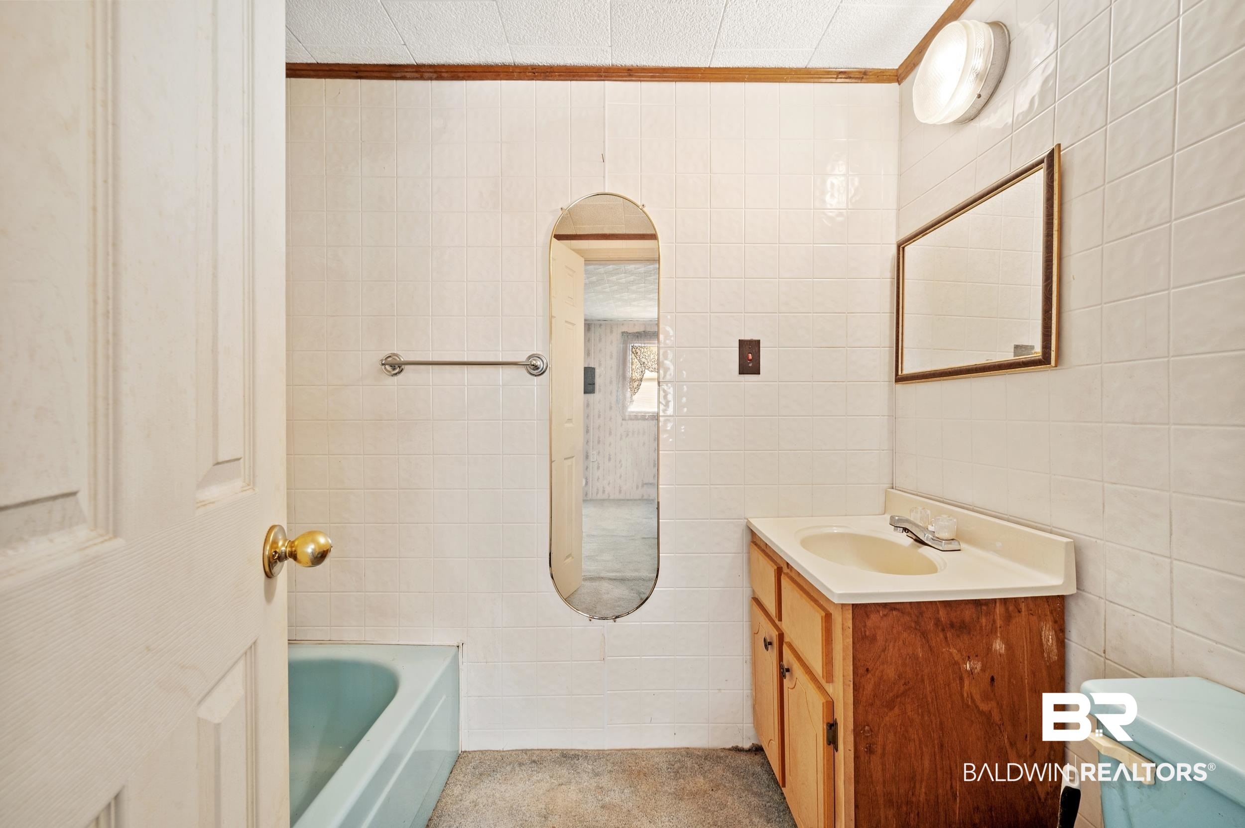 57623 Mary Hadley Road Perdido, AL 36562 - Photo 19 of 34 Full bathroom featuring a bathtub, tile walls, vanity, and ornamental molding