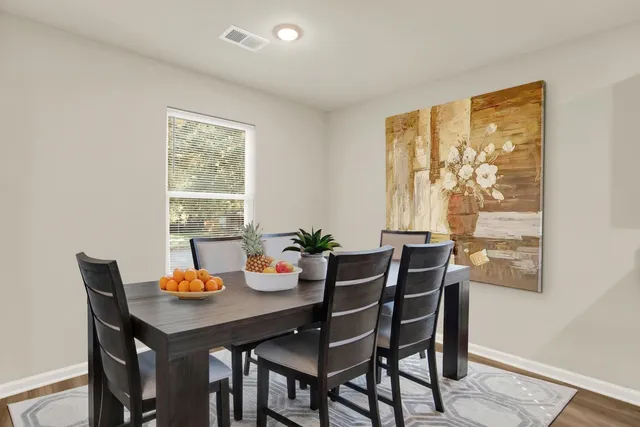 a view of a dining room with furniture window and wooden floor