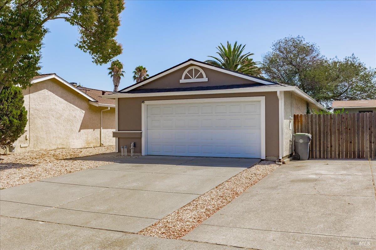 987 Daniel Street Fairfield, CA 94533 - Photo 3 of 36 a front view of a house with a yard and garage