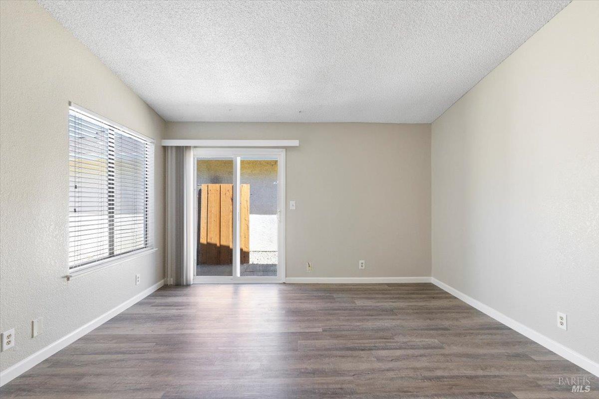 987 Daniel Street Fairfield, CA 94533 - Photo 6 of 36 a view of an empty room with wooden floor and a window