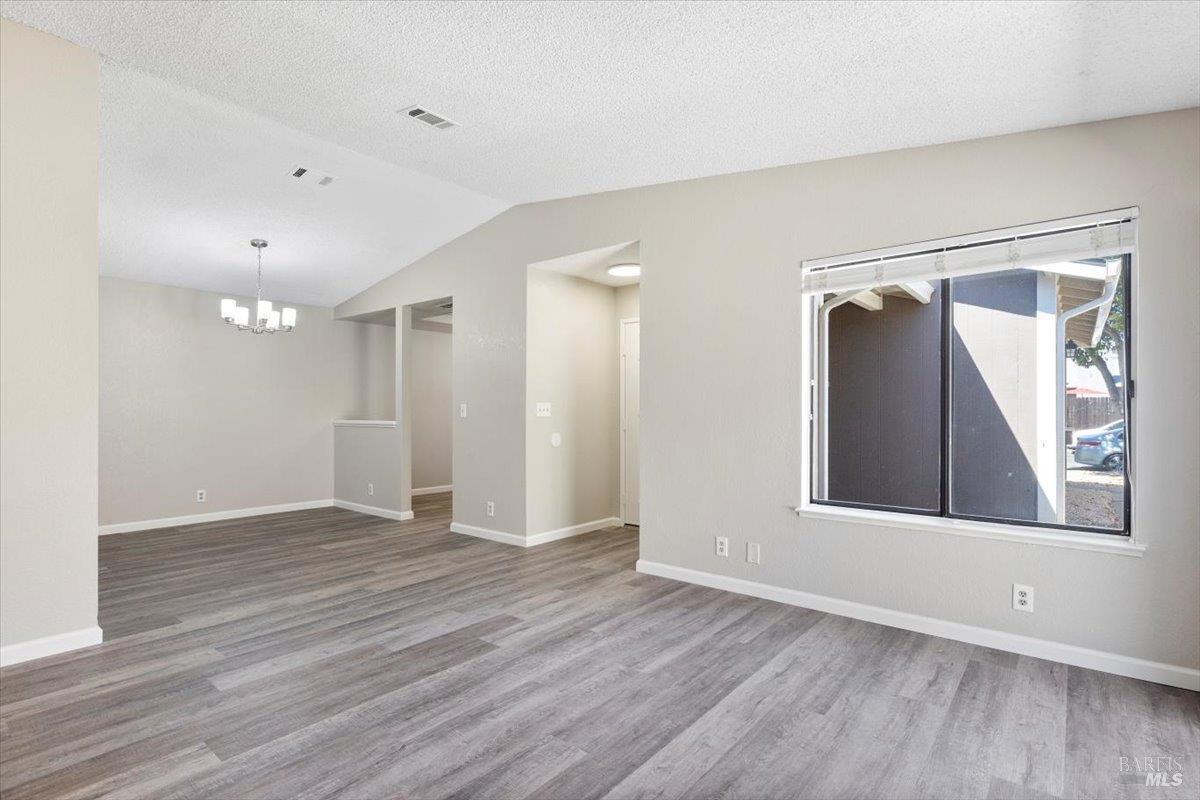 987 Daniel Street Fairfield, CA 94533 - Photo 8 of 36 a view of an empty room with wooden floor and a window