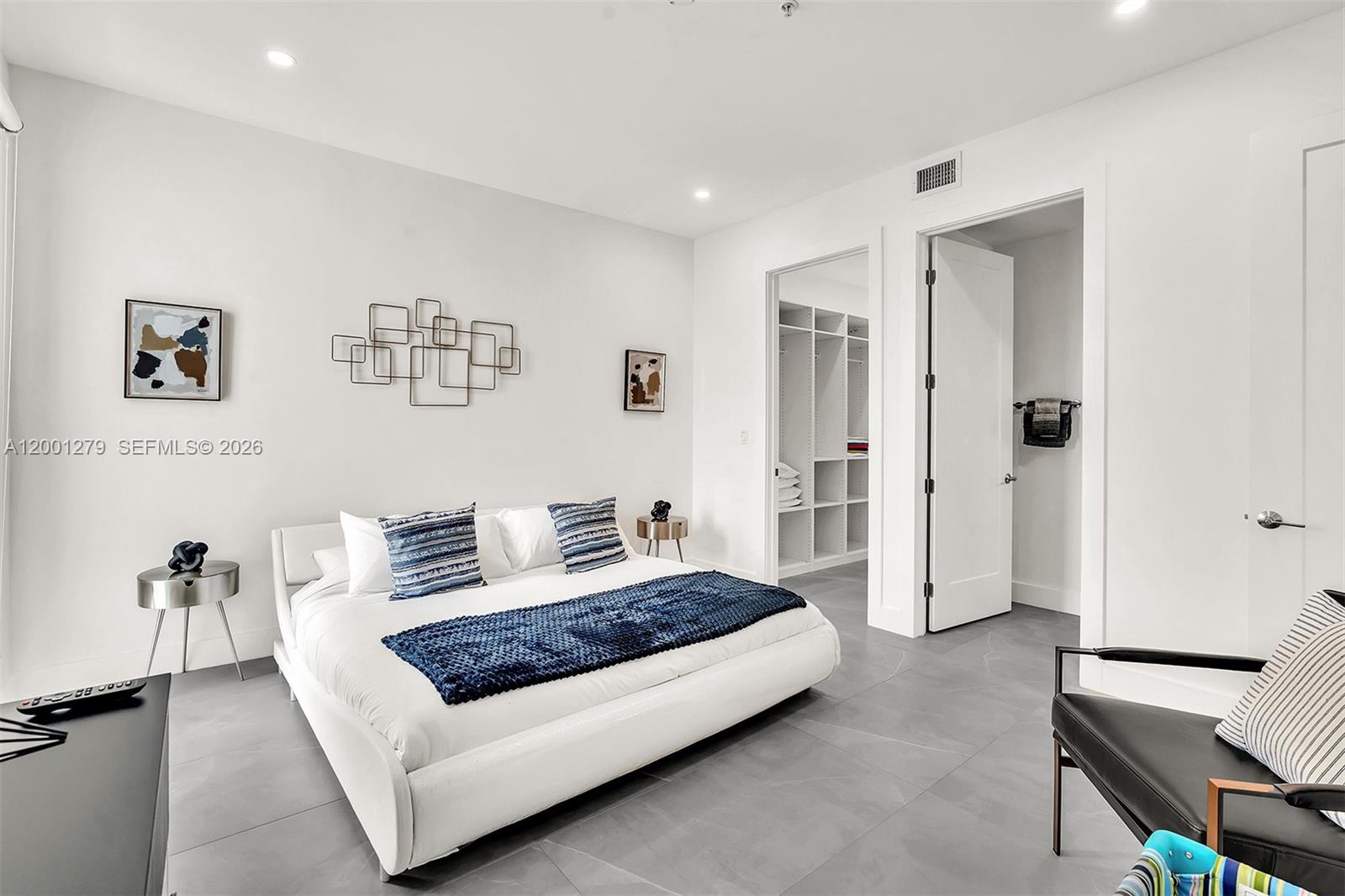 2100 Miami Road, Unit 403 Fort Lauderdale, FL 33316 - Photo 18 of 44 a spacious bedroom with a bed and a couch