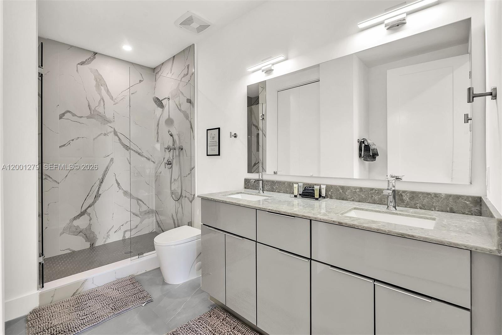 2100 Miami Road, Unit 403 Fort Lauderdale, FL 33316 - Photo 19 of 44 a bathroom with a double vanity sink mirror and toilet