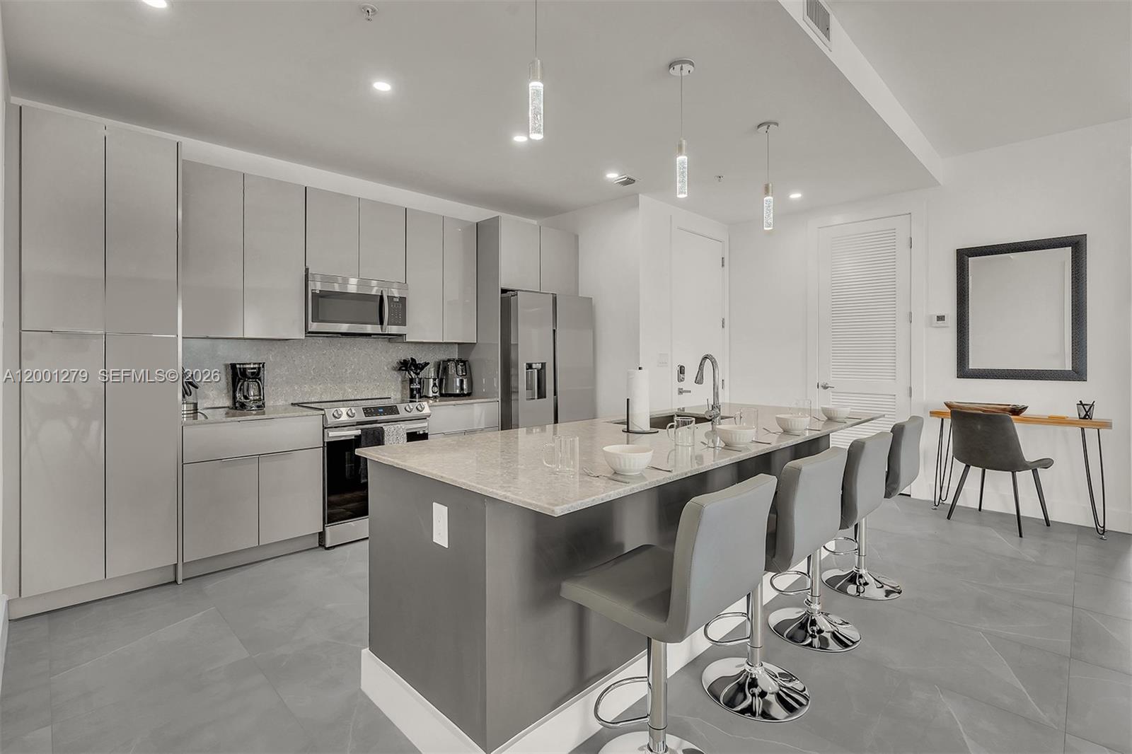 2100 Miami Road, Unit 403 Fort Lauderdale, FL 33316 - Photo 2 of 44 a kitchen with a sink white cabinets and appliances