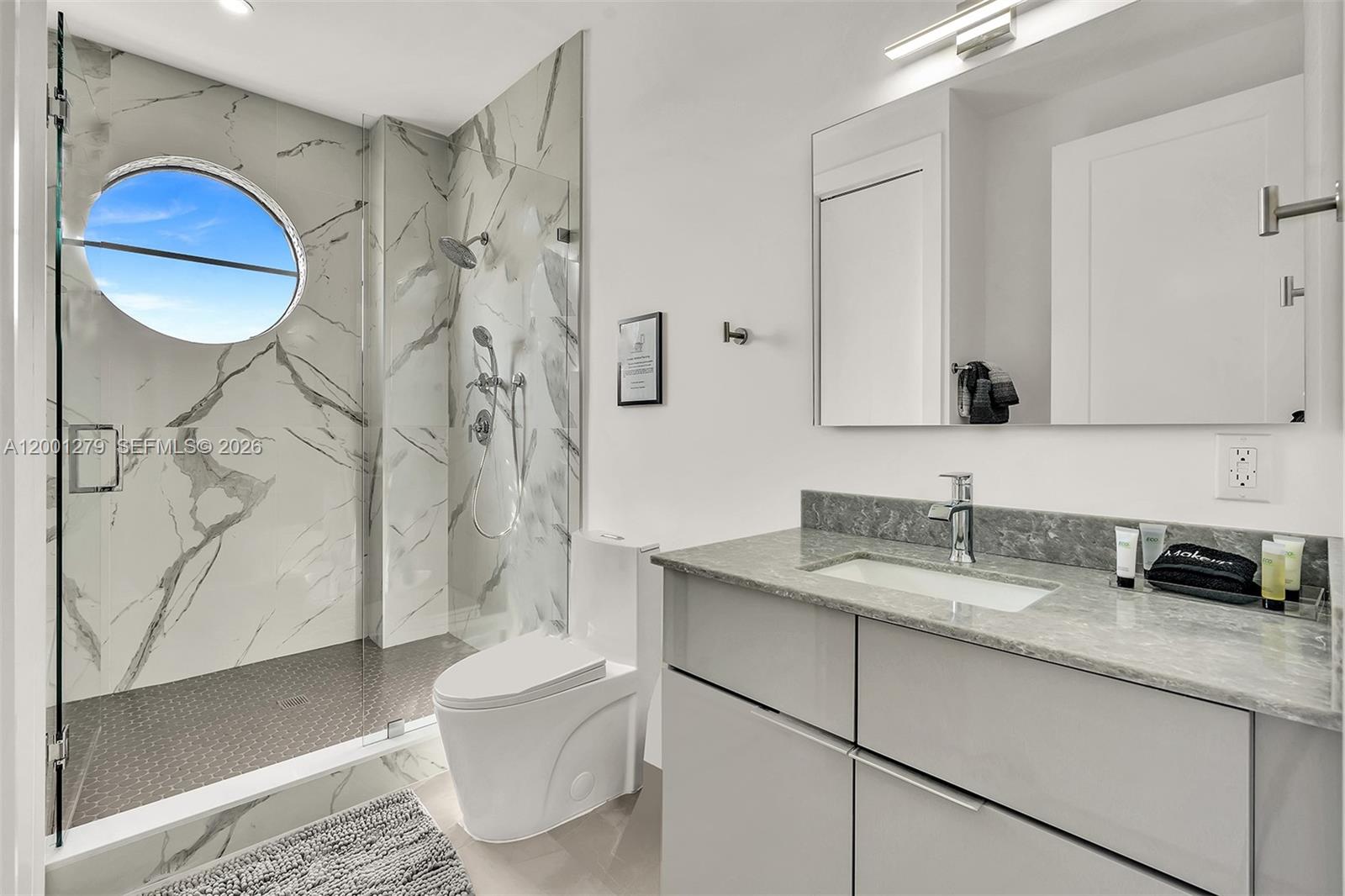 2100 Miami Road, Unit 403 Fort Lauderdale, FL 33316 - Photo 31 of 44 a bathroom with a granite countertop sink toilet and shower