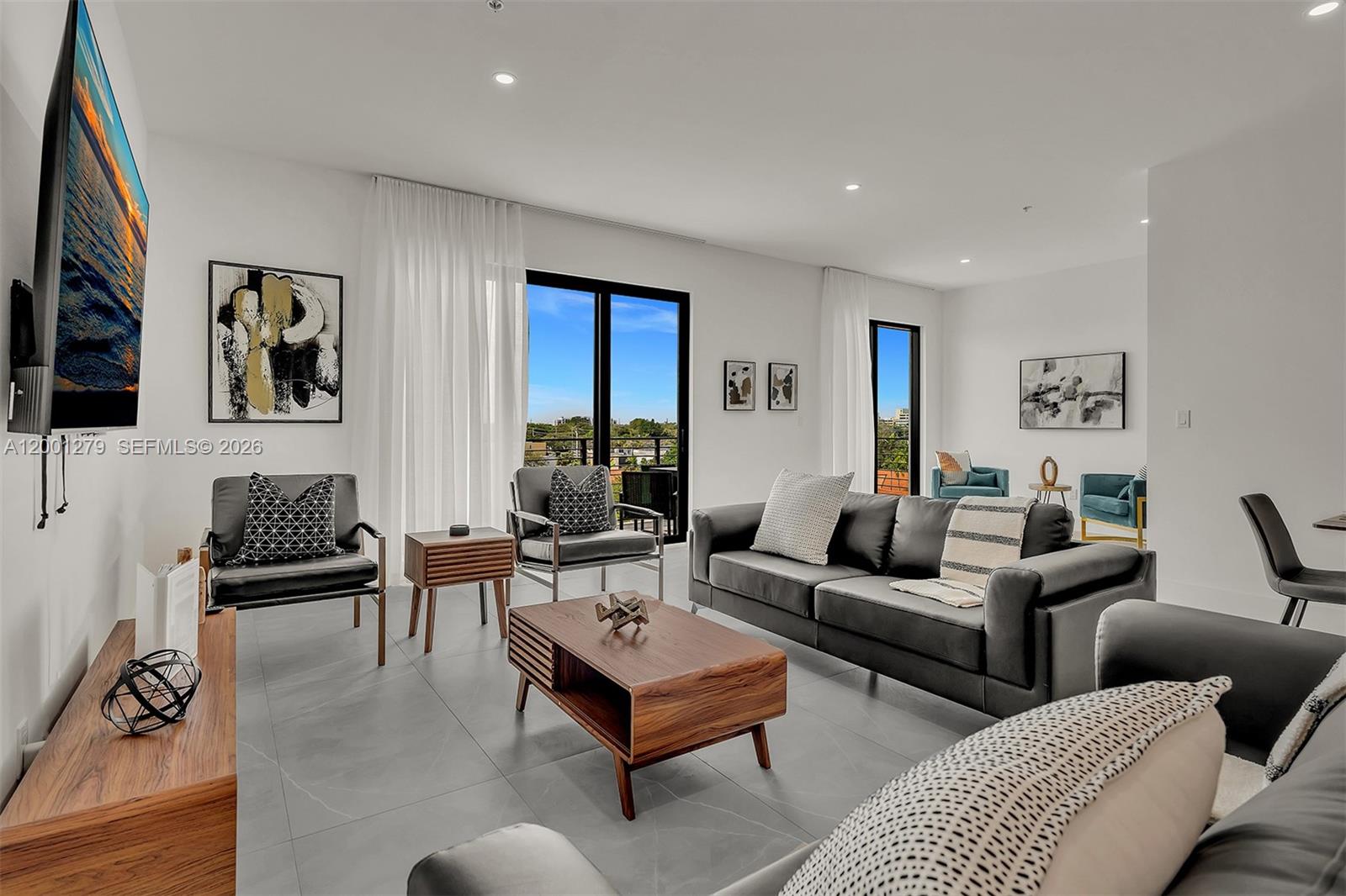 2100 Miami Road, Unit 403 Fort Lauderdale, FL 33316 - Photo 5 of 44 a living room with furniture potted plant and a window