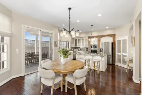 a dining room with furniture window and wooden floor