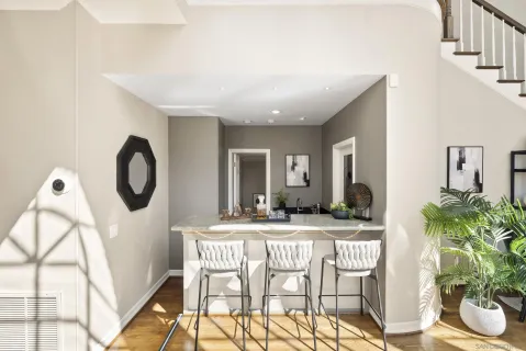 a dining room with furniture and a floor to ceiling window