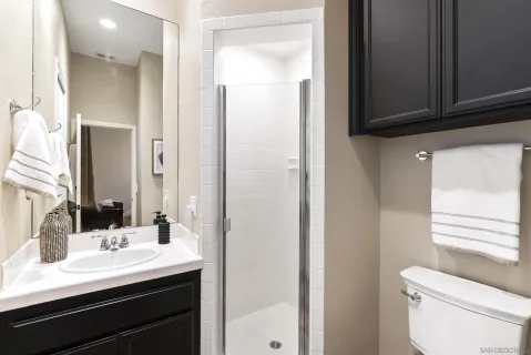 a bathroom with a sink and a mirror with toilet