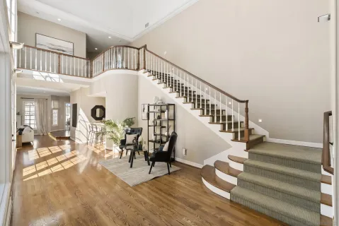 a view of entryway and hall with wooden floor