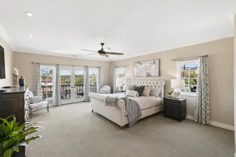 a spacious bedroom with a bed and ceiling fan