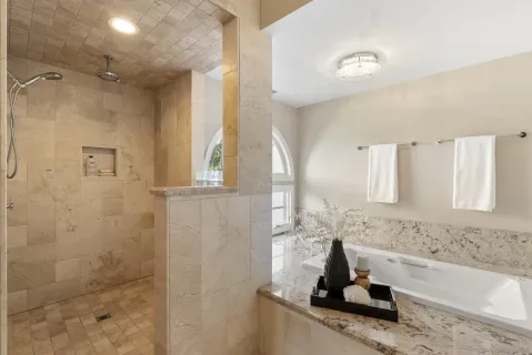 a bathroom with a tub sink and a mirror