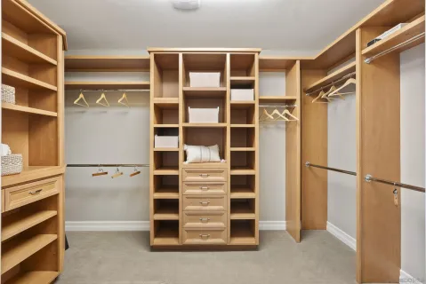 a view of walk in closet with empty racks